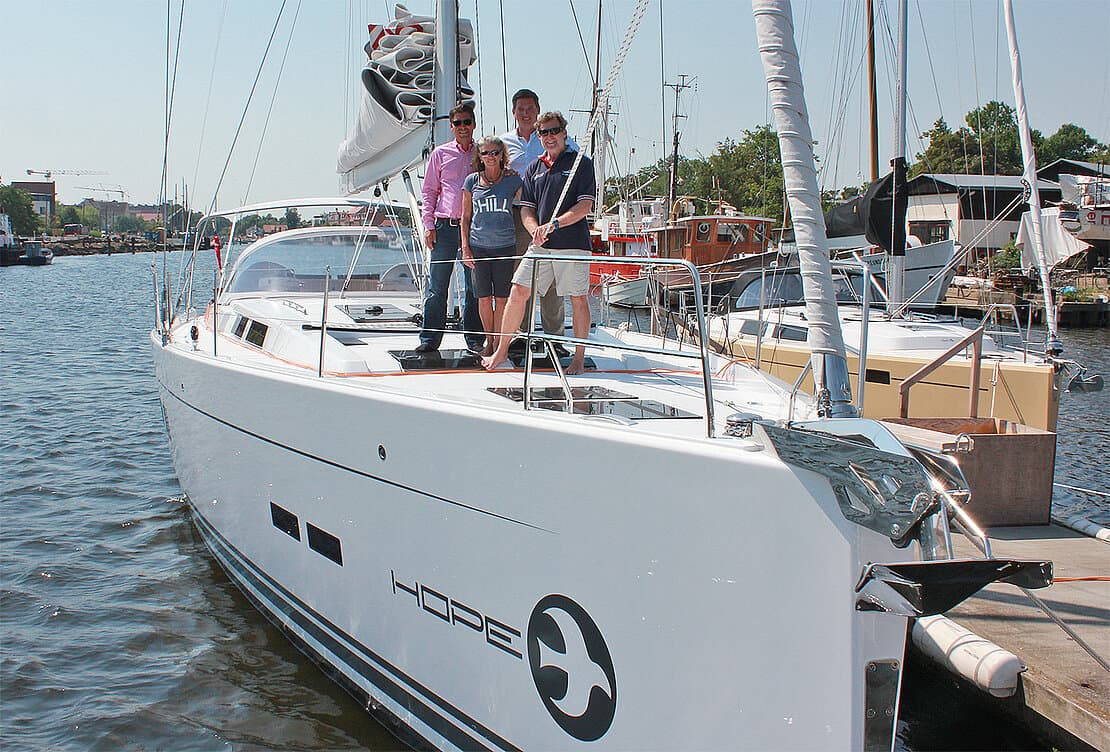 People on a Hanse 575 deck moored in the harbour